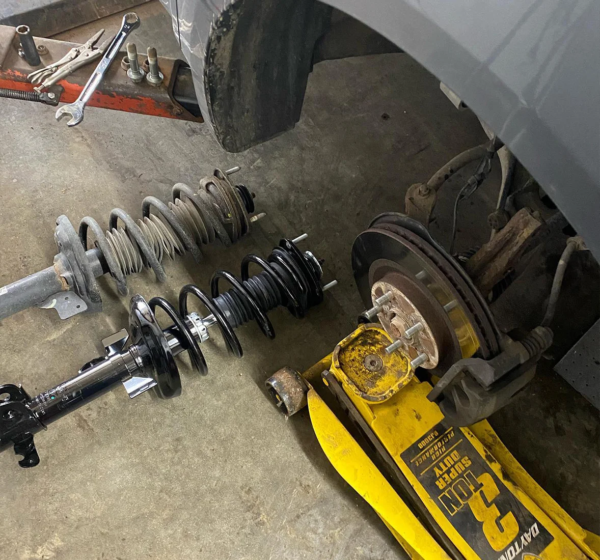Image of disassembled springs and suspension components. Concept image of suspension repair and services at Enright Automotive.