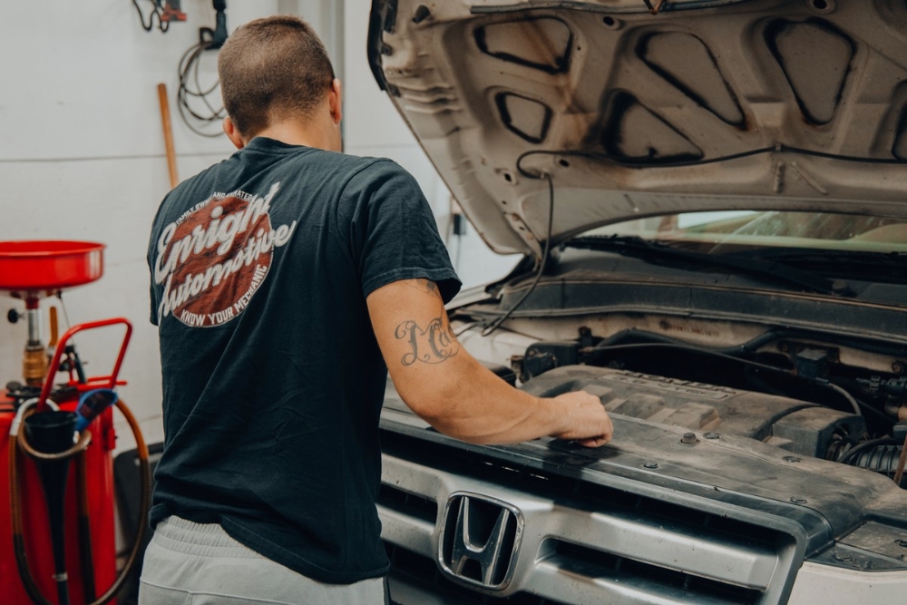 Back-to-School Car Care in Alexandria, OH At Enright Automotive. Mechanic performing car care inspection in auto repair shop