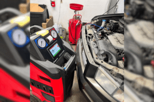 auto air conditioning repair, auto repair in Alexandria, OH at Enright Automotive.Image of a professional automotive A/C service machine connected to a vehicle during air conditioning diagnostics, refrigerant recovery, recharge, and system performance testing.
